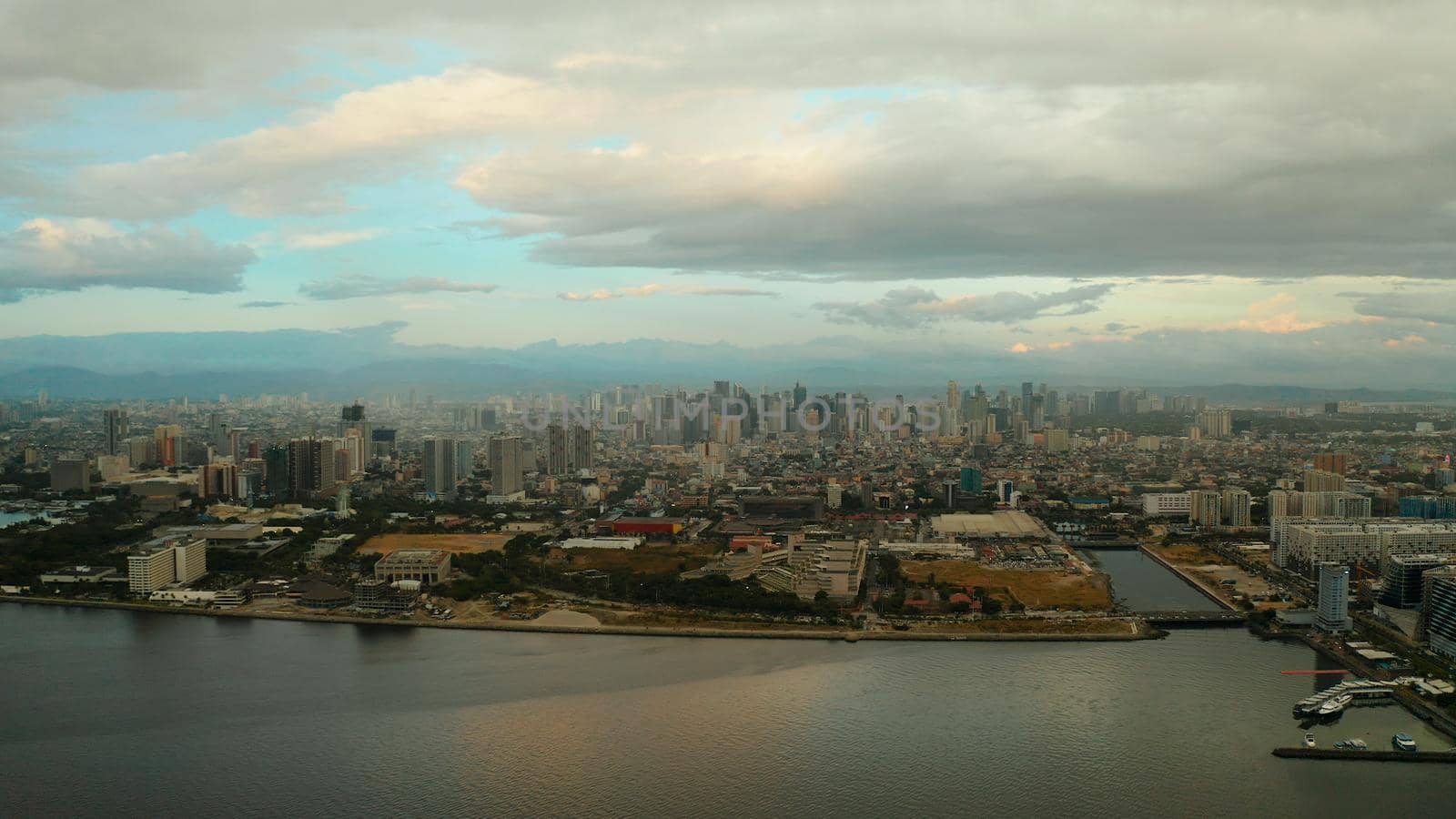 Aerial view of Panorama of Manila at sunset. Skyscrapers and business centers in a big city. Travel vacation concept