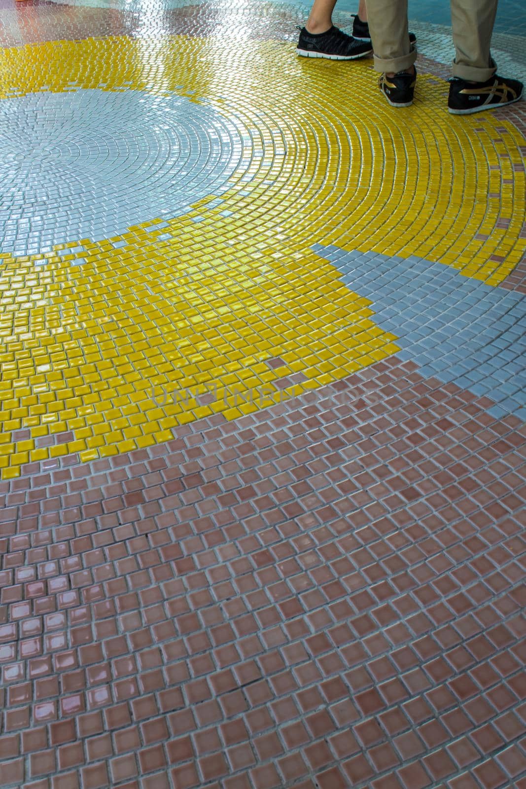 Yellow, White and Brown tiles on the floor of hall