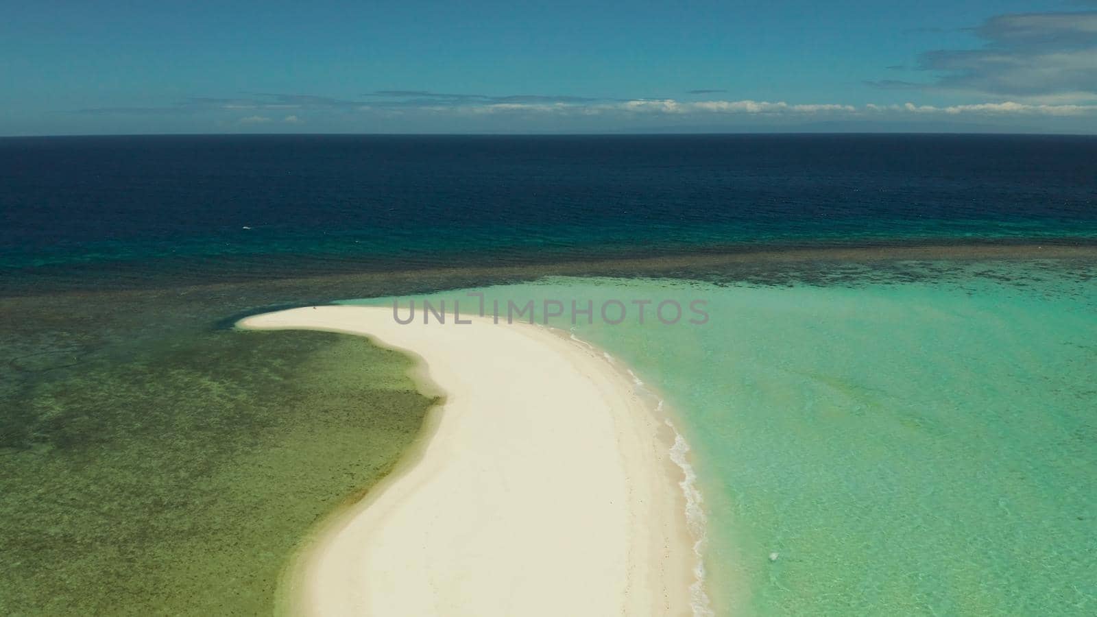 Beautiful beach on tropical island surrounded by coral reef, sandy bar, top view. Sandbar Atoll. Summer and travel vacation concept, Camiguin, Philippines.