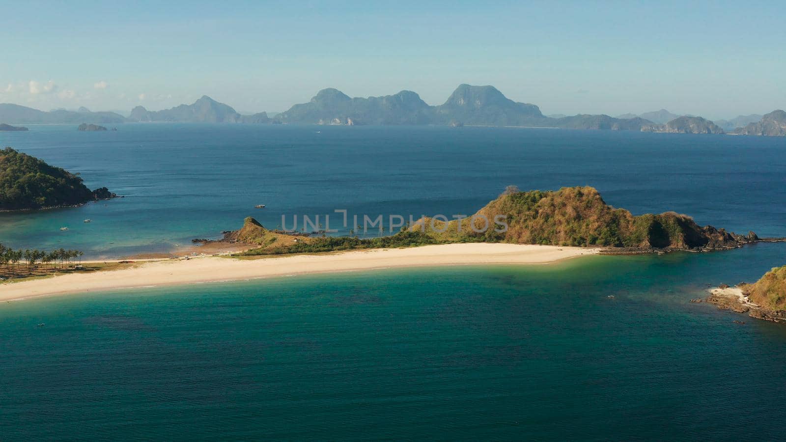 Tropical island with sandy beach, aerial view. Nacpan, El Nido, Palawan, Philippine Islands. Seascape with tropical beach and islands. Summer and travel vacation concept