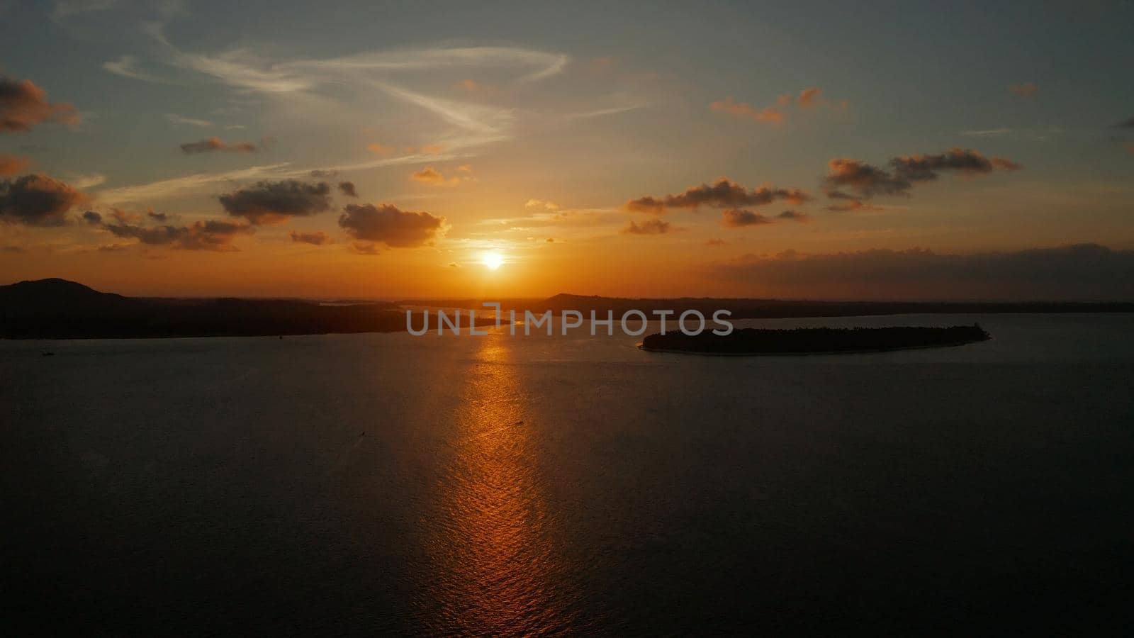 Colorful sunset over tropical islands, aerial view. Sunset over ocean. Balabac, Palawan, Philippines