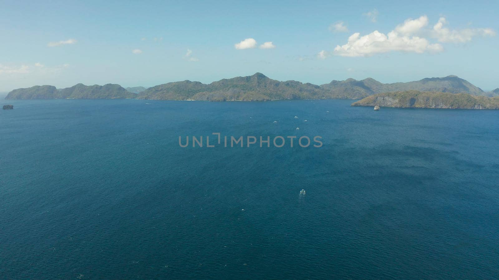 Aerial drone of Seascape with tropical rocky islands, blue water. islands and mountains covered with tropical forest. El nido, Philippines, Palawan