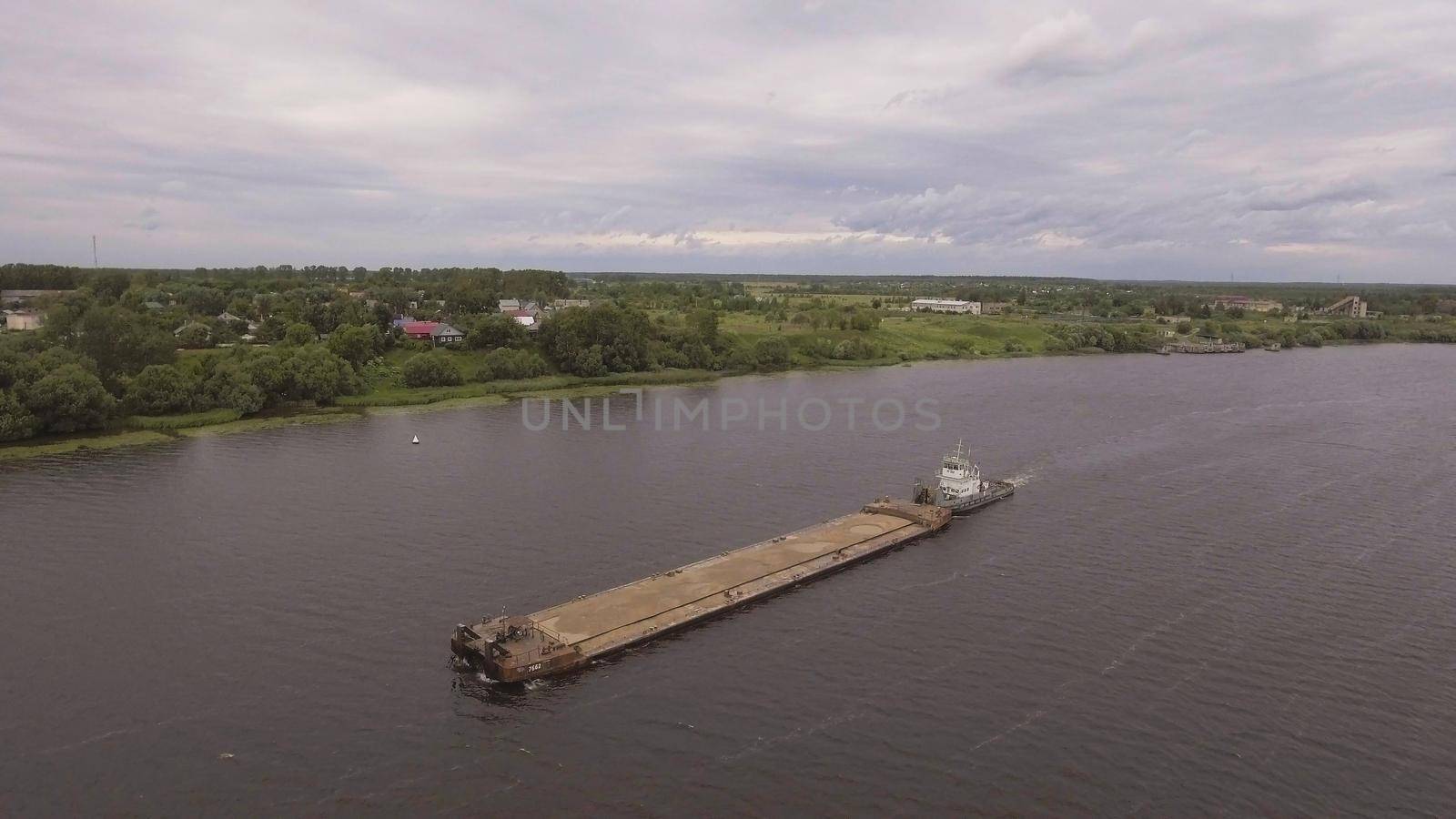 Aerial view:river barge on the beautiful river.Aerial:Cargo ship on the river Volga.