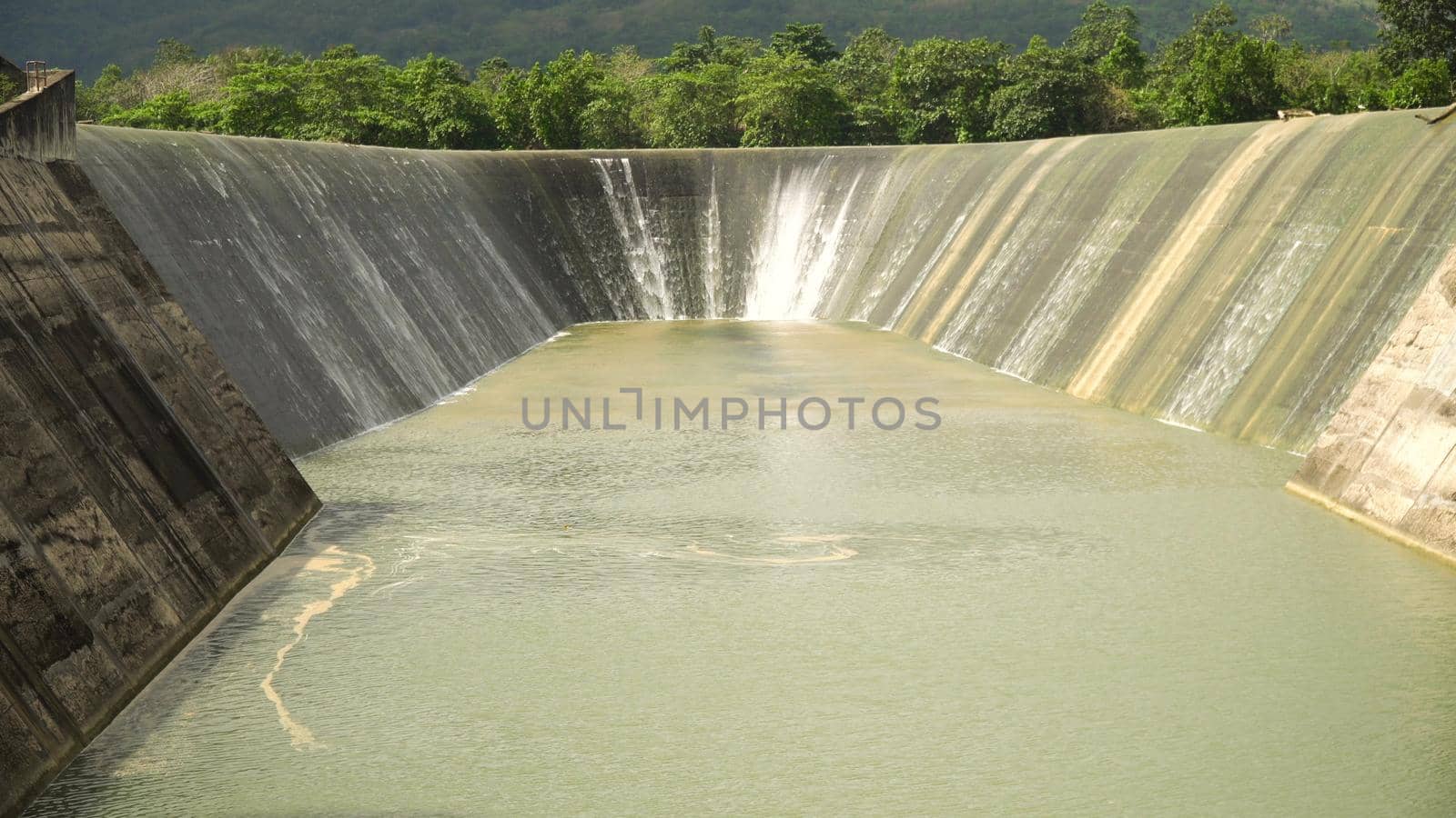 Dam on the lake in the rainforest on the island. Water flowing from the dam, Water for Irrigation countryside. Water Cascades Over Lake Bohol island, Philippines. .
