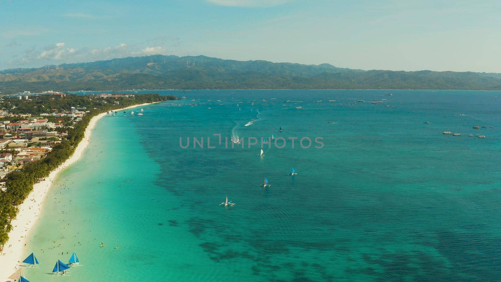 Tropical beach with tourists and clear blue sea, top view. Summer and travel vacation concept. Boracay, Philippines