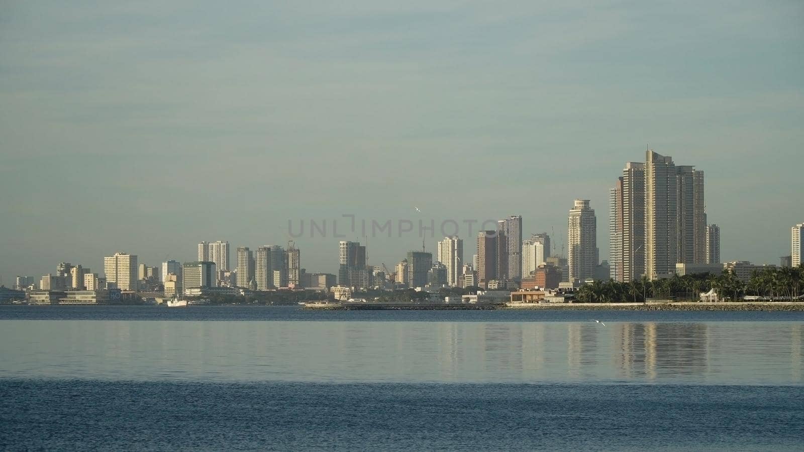 Manila city, skyscrapers and buildings. Seascape coastal city of Manila. Modern city by sea. Makati district. Travel concept.