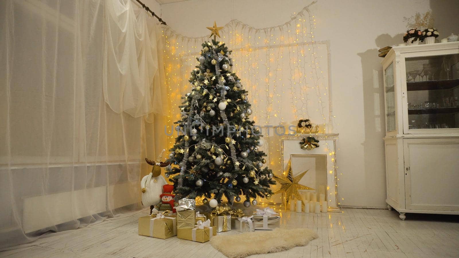 Decorated christmas tree with colorful balls and gifts. Christmas and New Year decorated interior room with presents and New year tree.