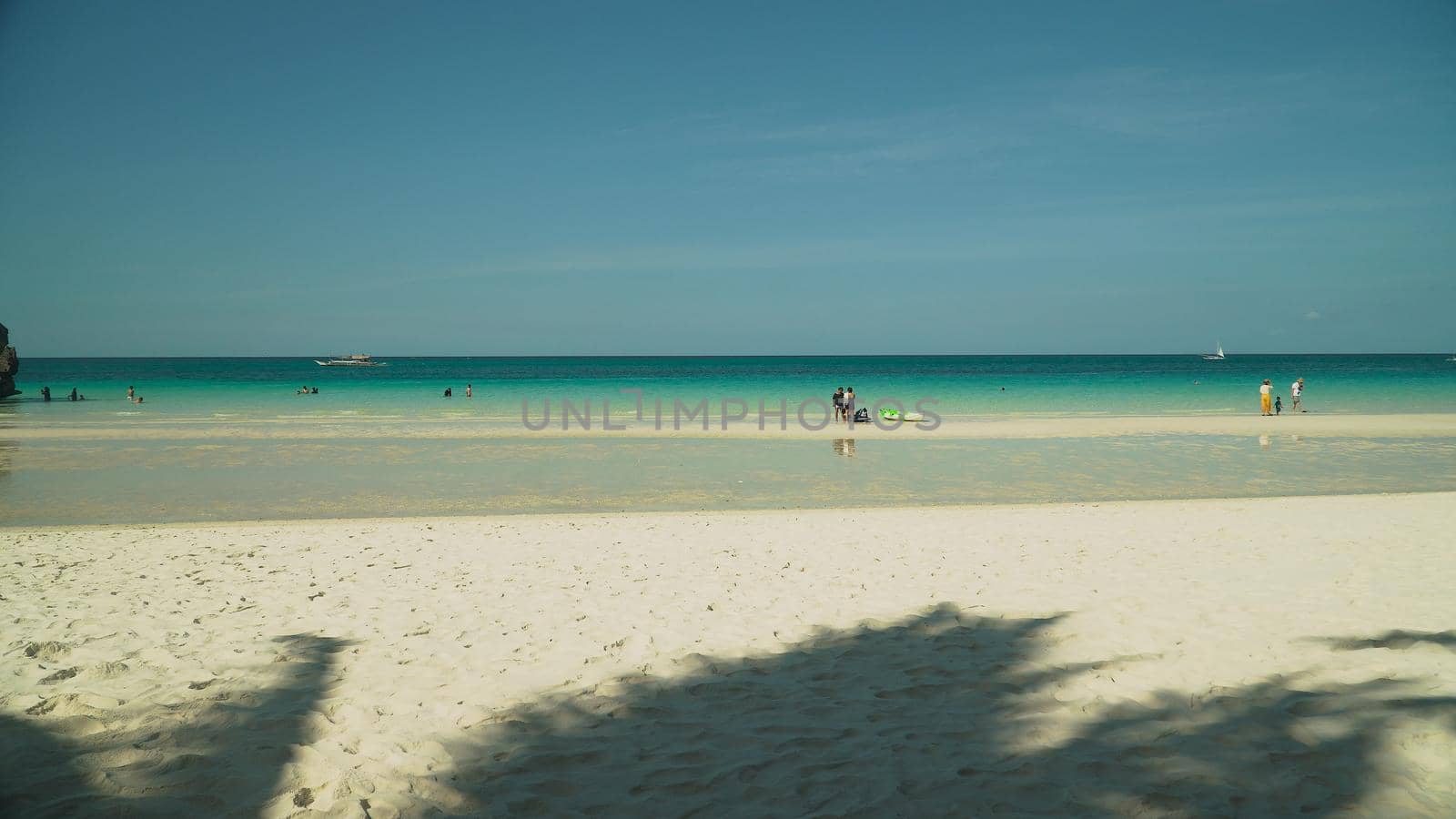 Tropical beach with tourists and clear blue sea. Summer and travel vacation concept. Boracay, Philippines
