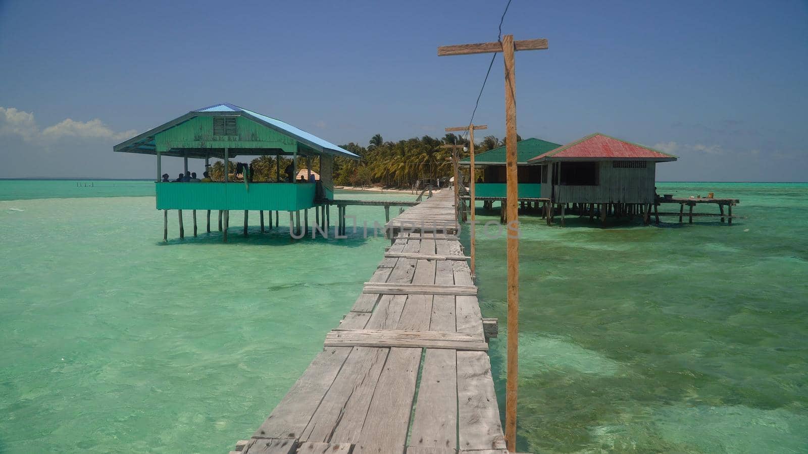 A pier with wooden arbors on a tropical island. Onok Island, Balabac, Philippines. Summer and travel vacation concept