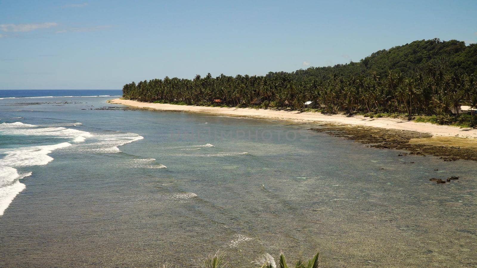 Beautiful tropical island with sand beach, palm trees.Seascape ocean and beautiful beach paradise, Siargao, Philippines. Tropical landscape: beach with palm trees. Travel concept.