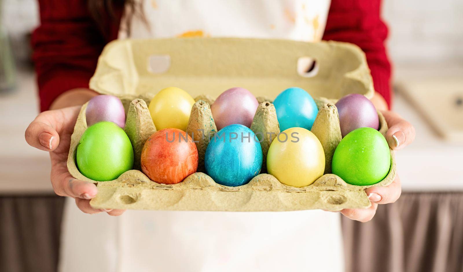 Woman hands holding pack of colorful easter eggs