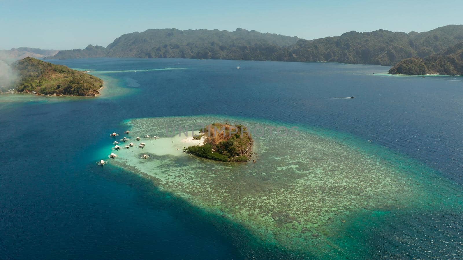 aerial view tropical island with sand white beach, clear and blue water. CYC Beach, Philippines, Palawan. Tropical landscape with blue lagoon, coral reef. travel concept