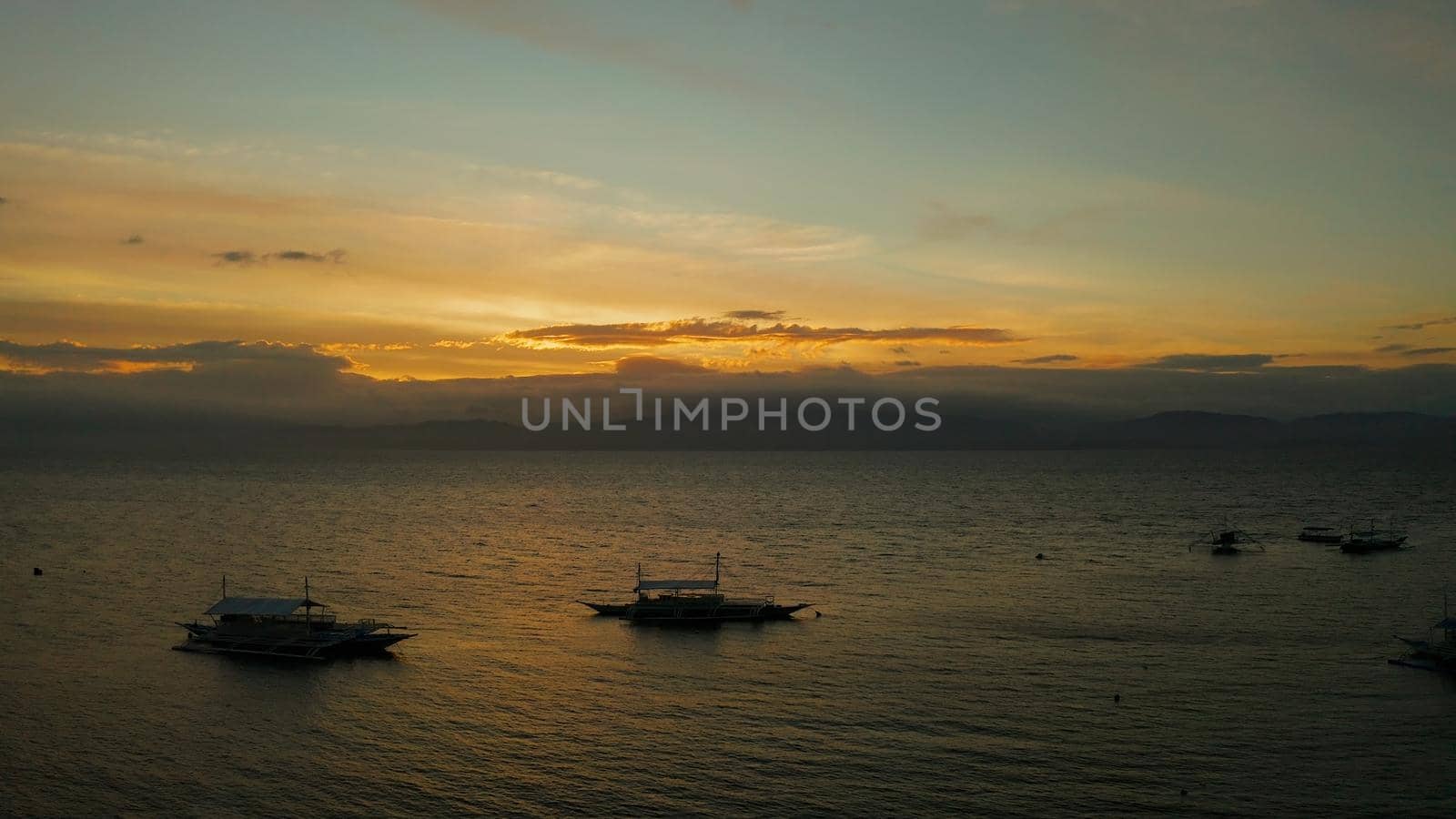 Colorful bright clouds during sunset over the sea, aerial view. Sunset over ocean. Seascape, Summer and travel vacation concept, Moalboal, Philippines.