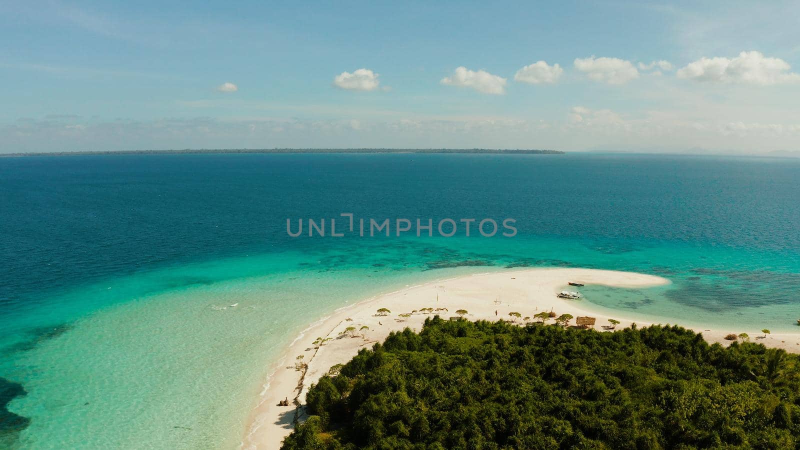 Tropical landscape: small island with beautiful beach, palm trees by turquoise water view from above. Patawan island with sandy beach. Summer and travel vacation concept.