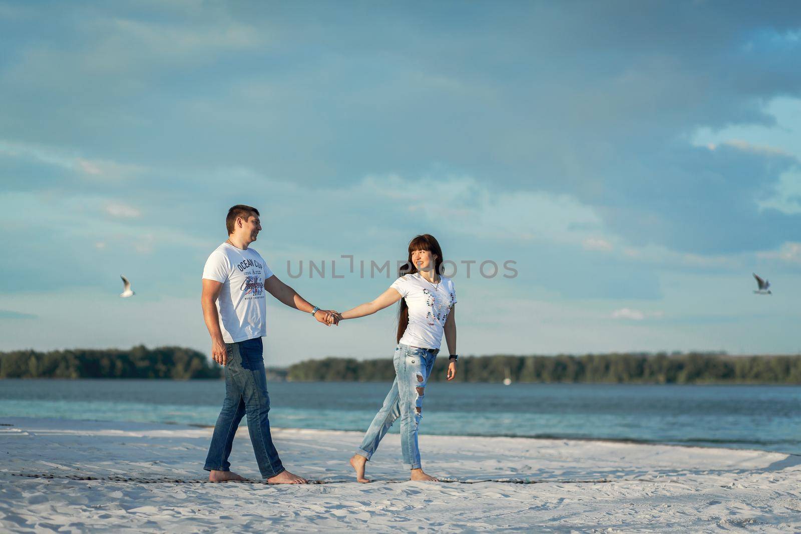 Young couple romantic date at sand beach.