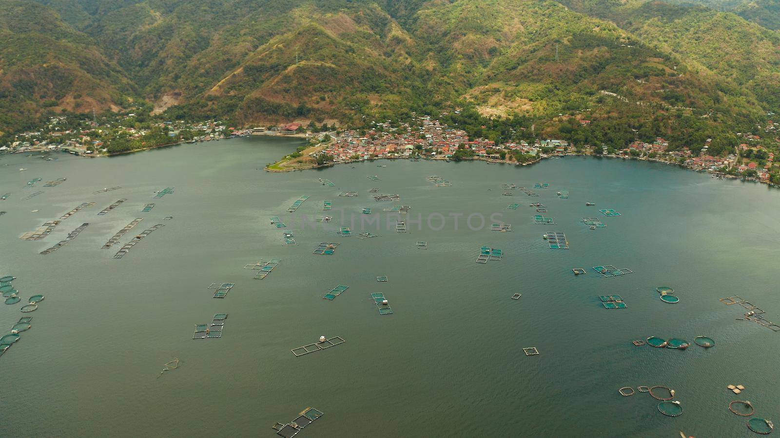 Aerial view of fish farm with cages for fish and shrimp on the lake Taal, Philippines, Luzon. Fish ponds for bangus, milkfish.