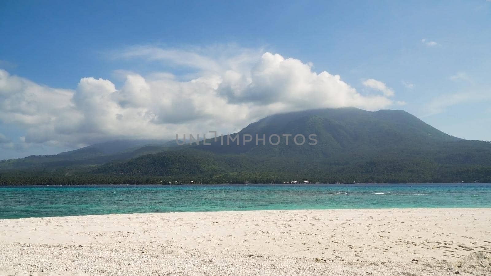 Seascape ocean,mountains and beautiful beach paradise. Beach, sea, sand,wave. Tropical beach, blue sky, clouds Philippines Camiguin Travel concept