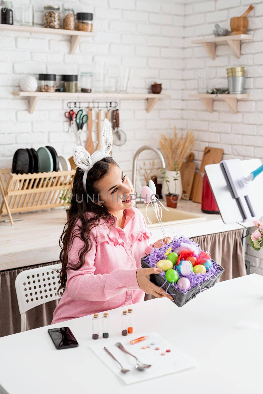 beautiful woman greeting her friends online, celebrating easter