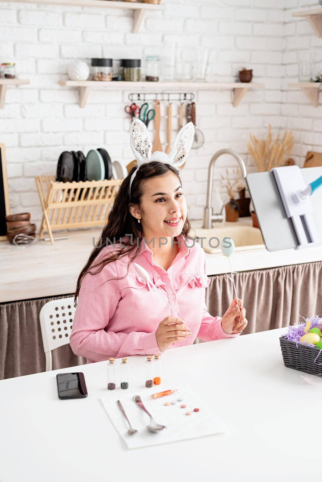 beautiful woman greeting her friends online, celebrating easter