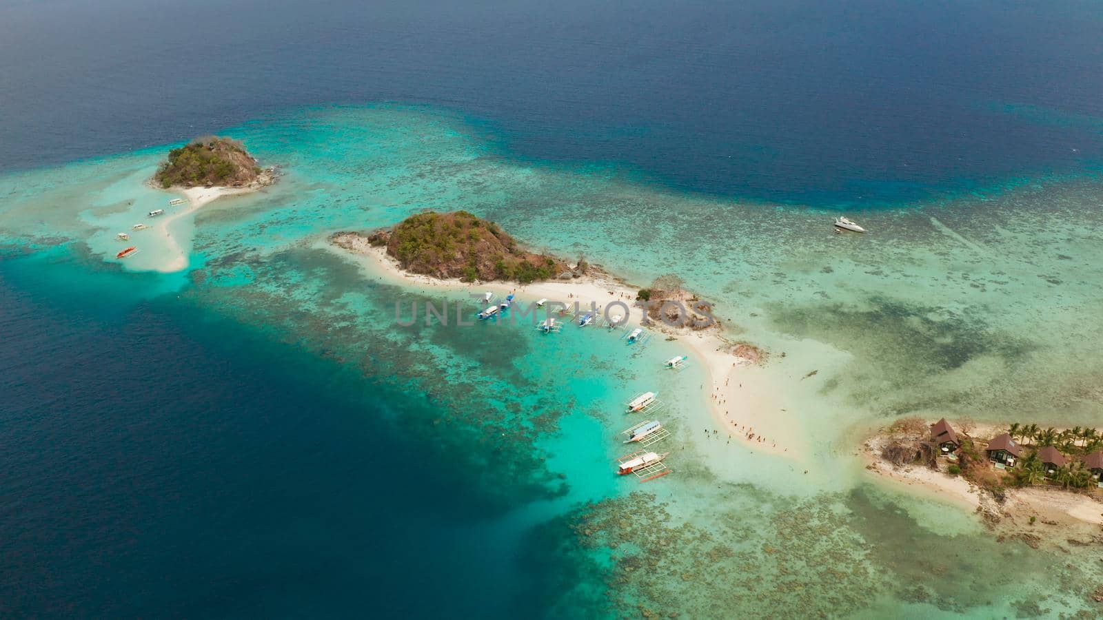 aerial view tropical island with sand white beach. Bulog Dos, Philippines, Palawan. Seascape bay with turquoise water and coral reef.
