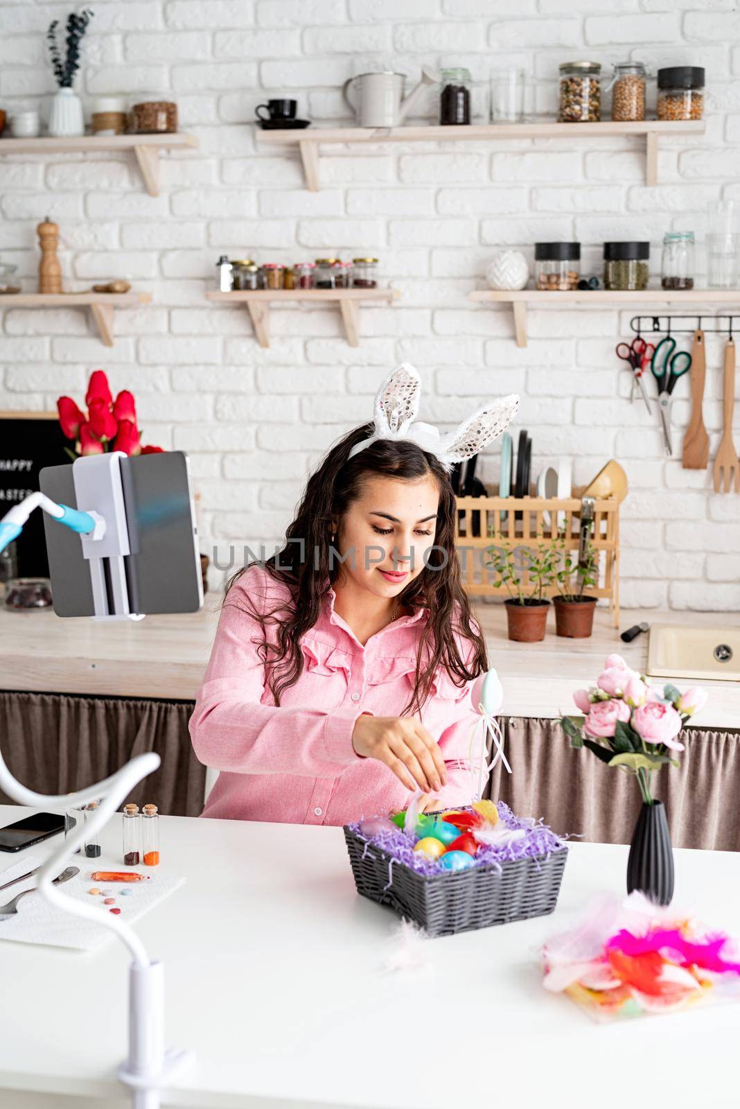 beautiful woman greeting her friends online, celebrating easter