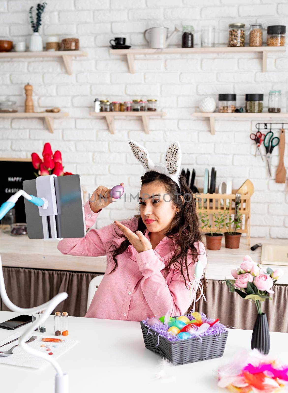 beautiful woman greeting her friends online, celebrating easter