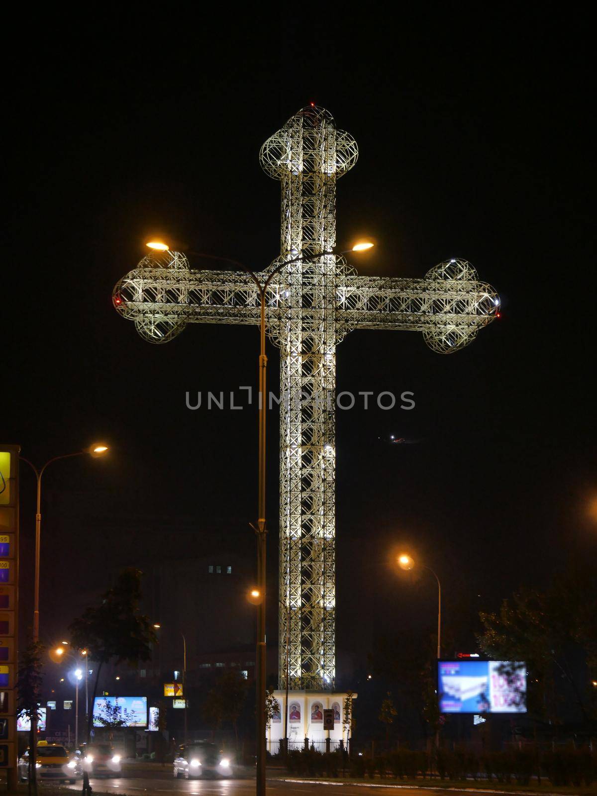 Orthodox cross light in night at city