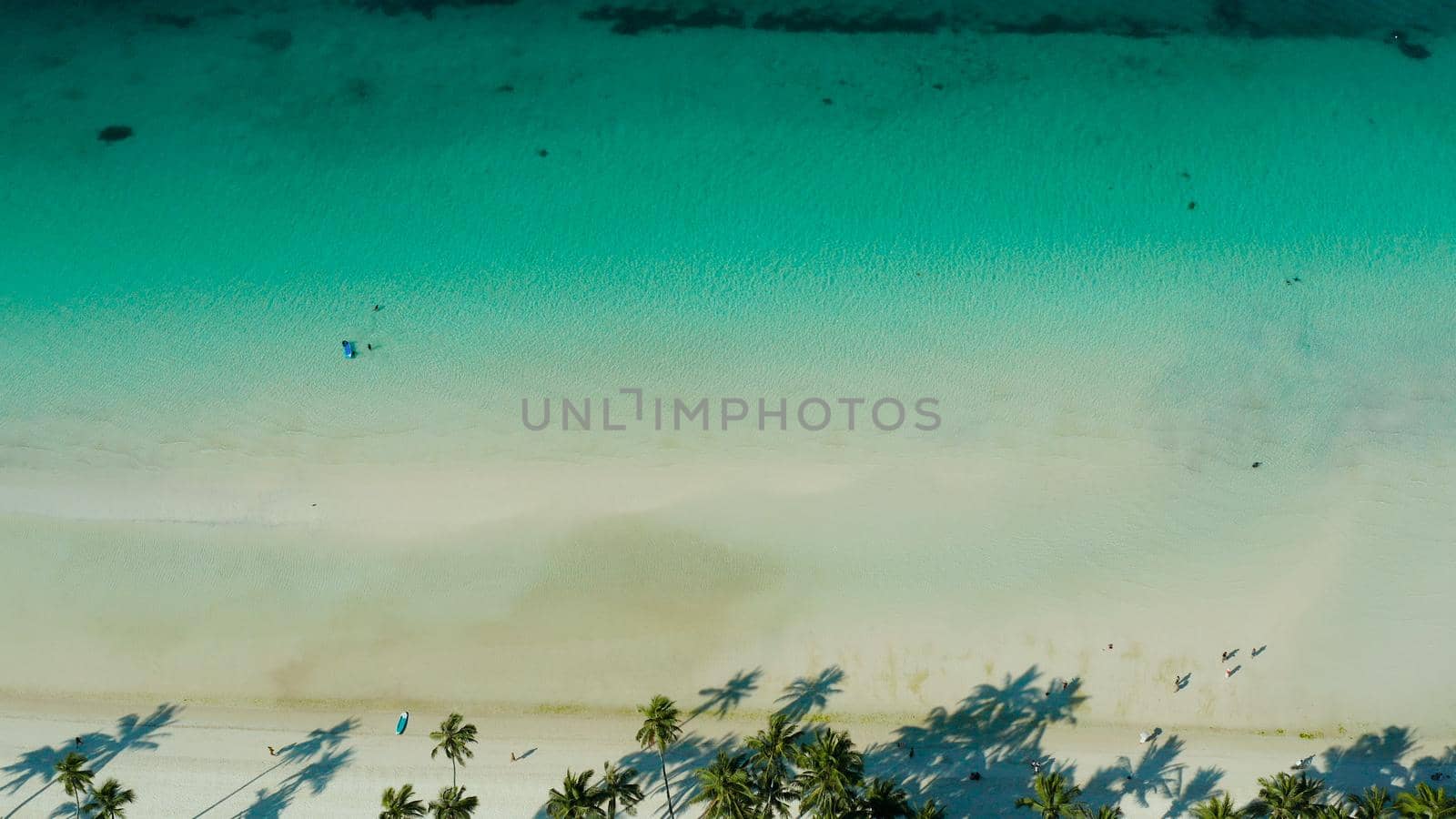 Tropical sandy beach with wave and turquoise water,copy space for text, aerial view. Ocean with waves and tropical beach. Summer and travel vacation concept