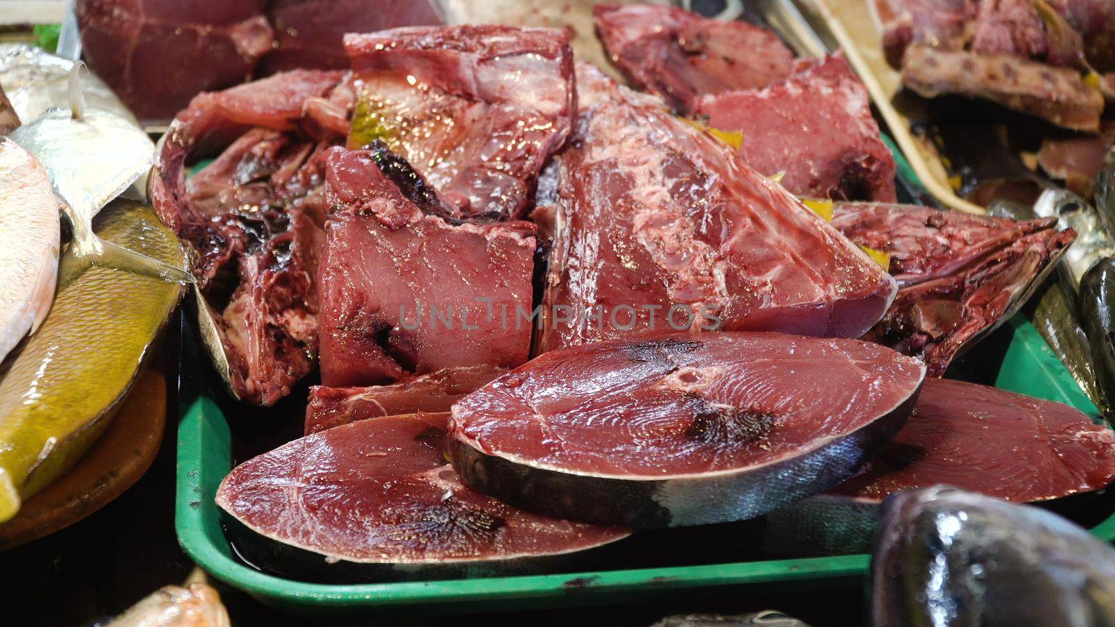 Fresh Tuna fish in Asian market. Sale of fresh sea fish in the Asian public store. Sea fish lying on the shopboard at one of the street markets. Philippines.