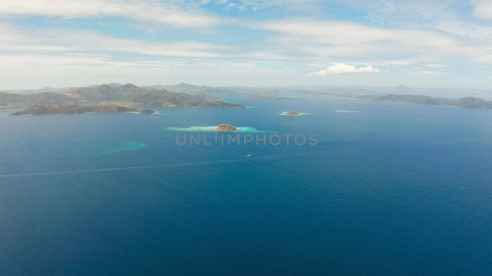 aerial seascape Lagoons with blue, azure water in middle of small islands. Palawan, Philippines. tropical islands with blue lagoons, coral reef. Islands of the Malayan archipelago with turquoise lagoons.