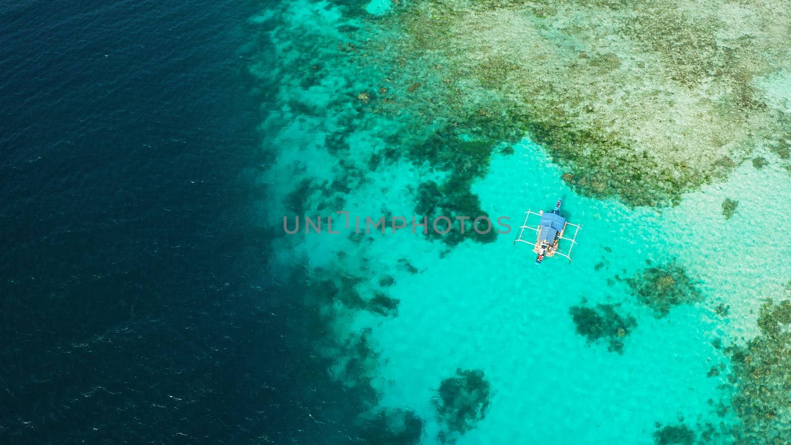Turquoise lagoon surface on atoll and coral reef, copy space for text. Top view transparent turquoise ocean water surface. background texture