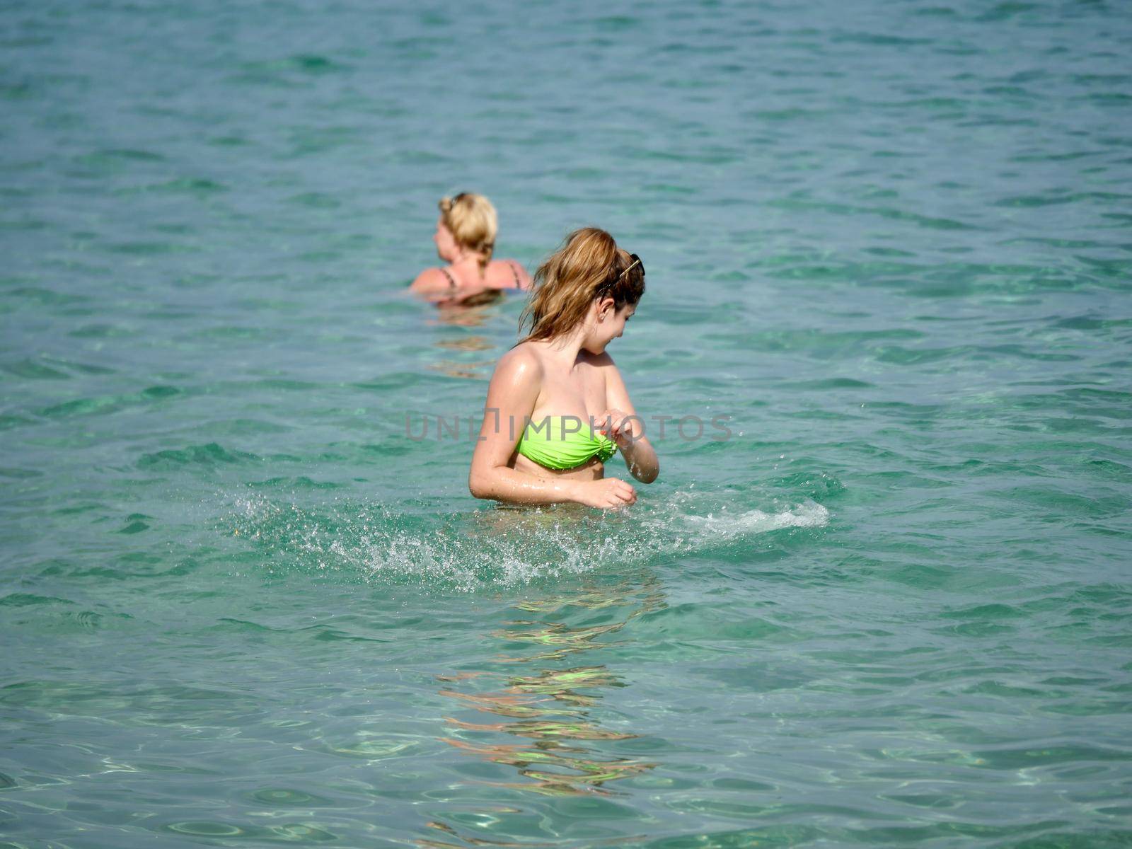 long woman play on the blue sea