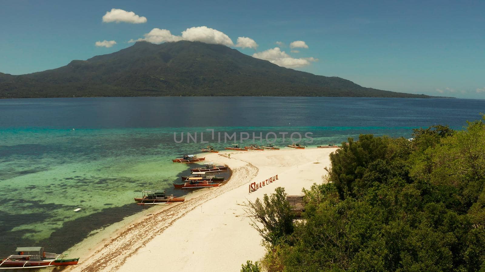 Tropical island with sandy beach with atoll and coral reef, aerial drone. Island on turquoise atoll. Summer and travel vacation concept, Camiguin, Philippines, Mindanao
