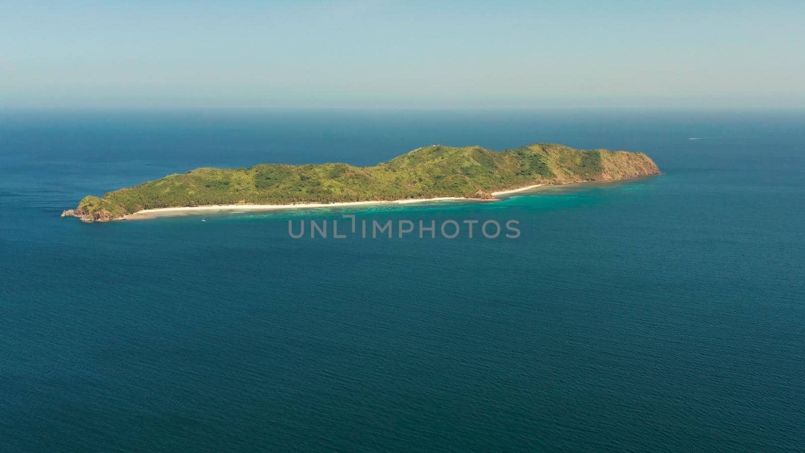 Tropical island with beach and blue water, aerial view. island and mountains covered with tropical forest. El nido, Philippines, Palawan. Summer and travel vacation concept