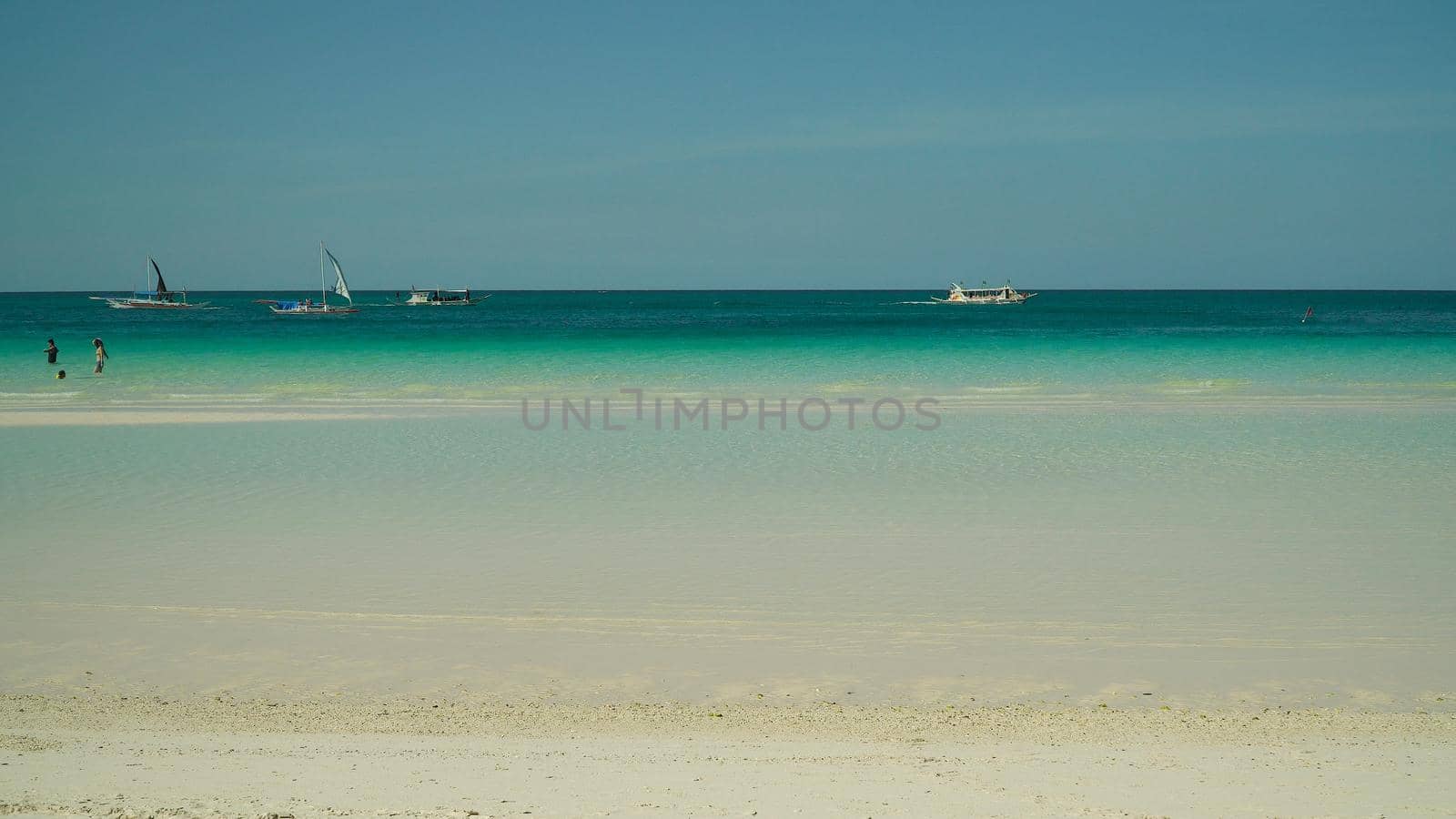 Tropical beach with boats and yachts on a background of sky. Summer and travel vacation concept.