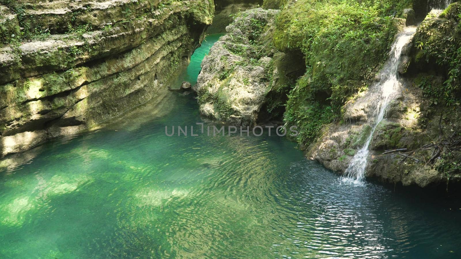 Beautiful waterfall in green forest in jungle. Waterfall in the mountains. Tropical rain forest with waterfall. Philippines, Cebu. Travel concept.