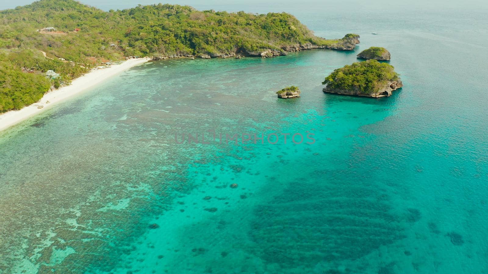 Tropical sandy beach near the blue lagoon and corall reef, aerial view Boracay, Philippines. Ilig Iligan Beach. Summer and travel vacation concept.