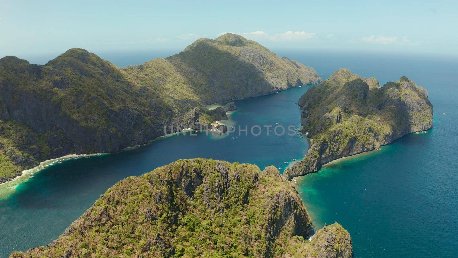 Seascape with tropical rocky islands, ocean blue water, aerial view . islands and mountains covered with tropical forest. El nido, Philippines, Palawan. Tropical Mountain Range