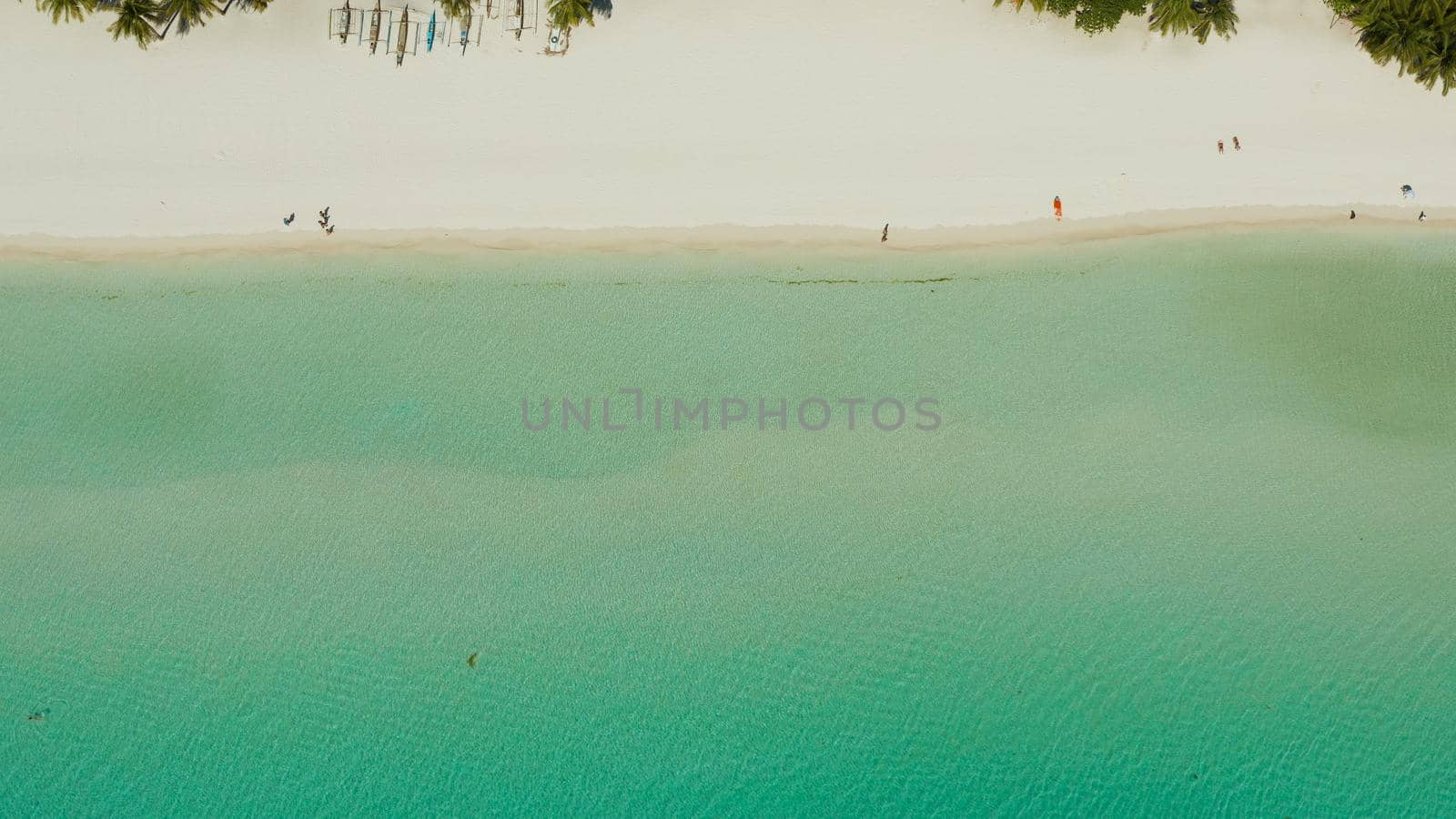 Tropical white sand beach in a lagoon with turquoise water on Boracay Island, Philippines., aerial view. Seascape with beach on tropical island. Summer and travel vacation concept.
