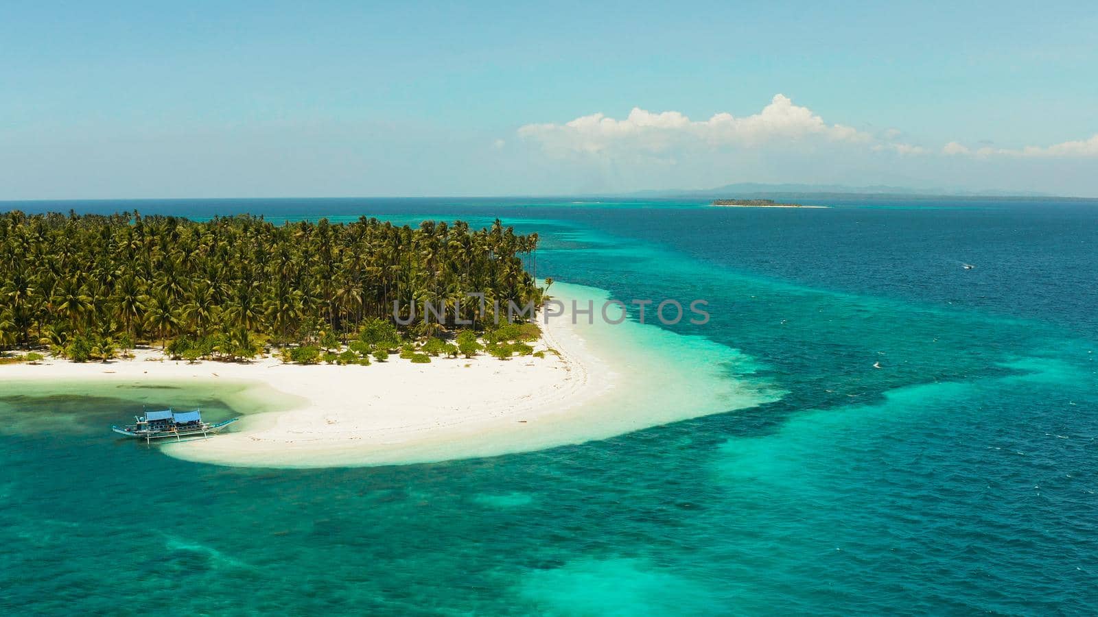 Sandy beach and tropical island by atoll with coral reef, top view. Patongong Island with sandy beach. Summer and travel vacation concept.