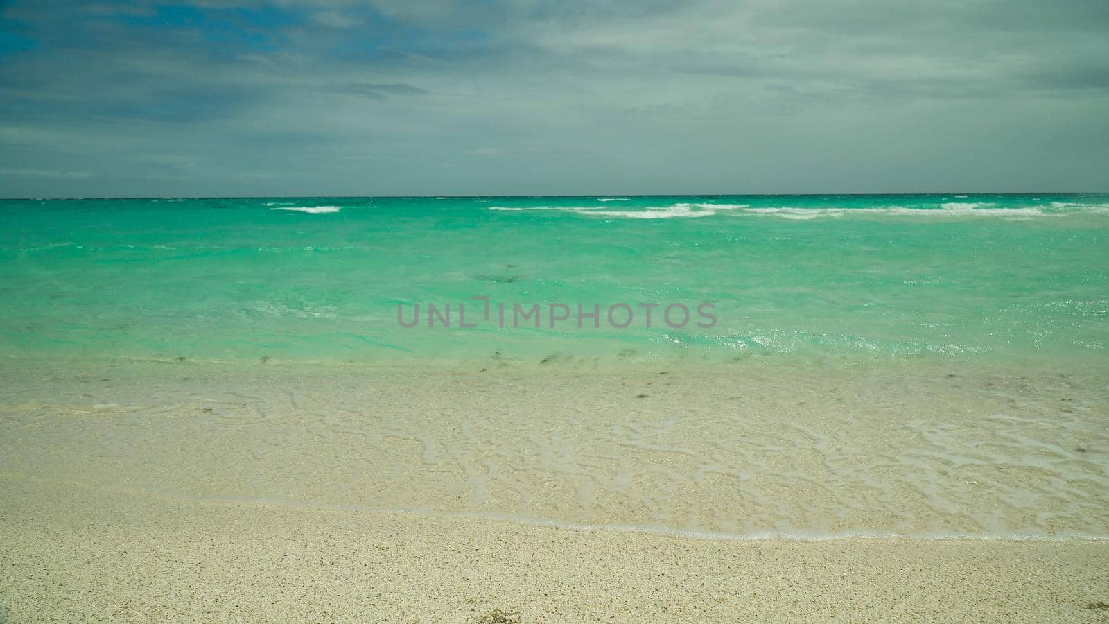 Beautiful tropical and turquoise sea with waves. Summer and travel vacation concept.
