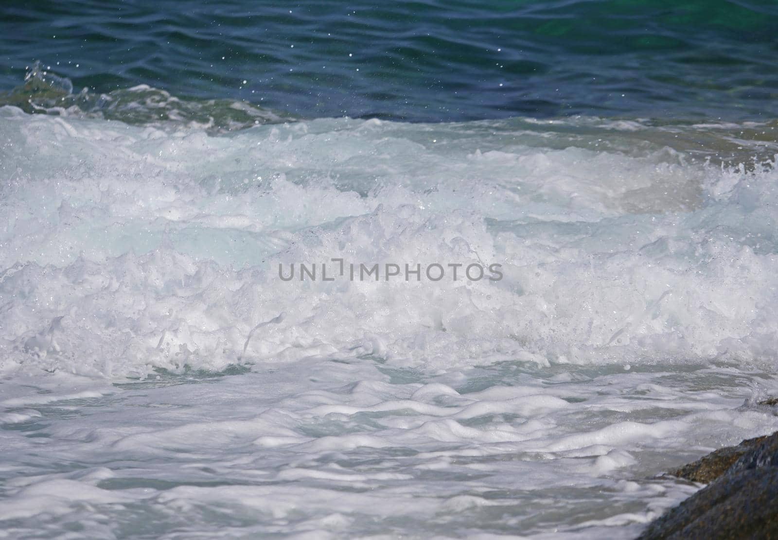 Waves crashing against the rock, natural background