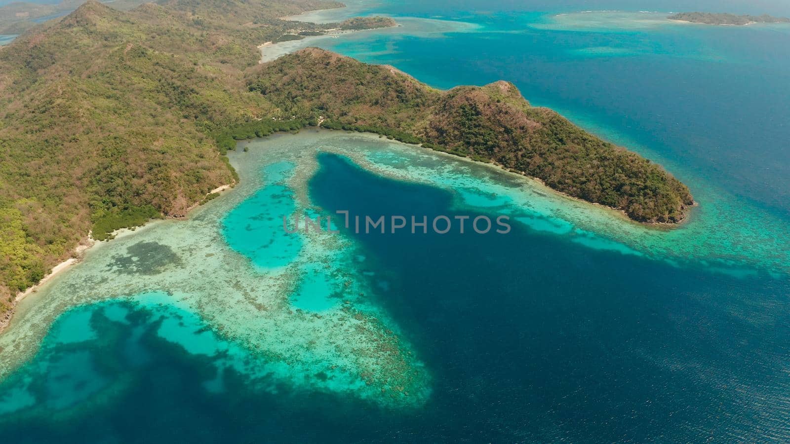 aerial drone tropical islands with blue lagoons, coral reef and sandy beach. Palawan, Philippines. Islands of the Malayan archipelago with turquoise lagoons.