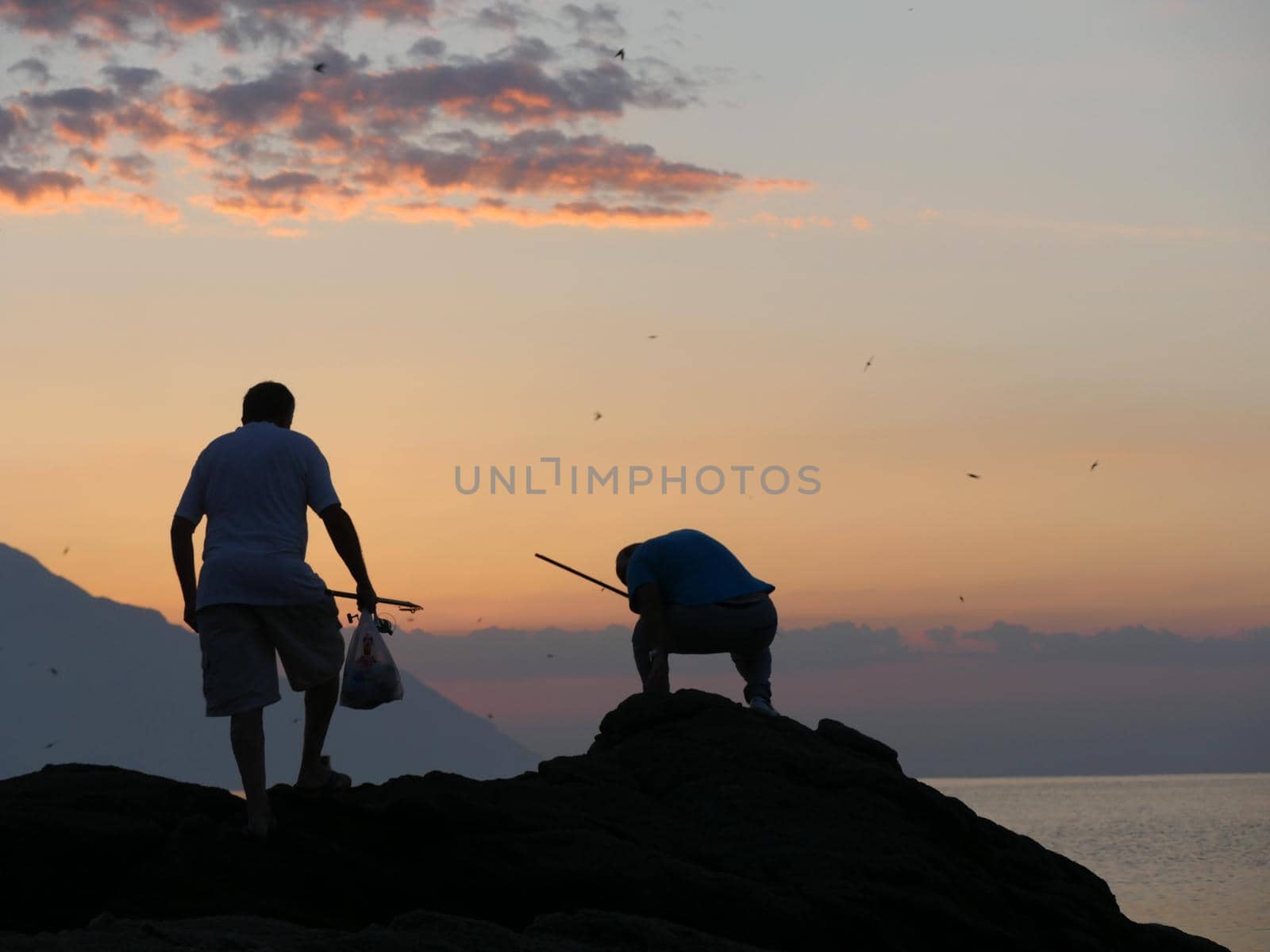 fishermen are getting ready to hunt fish at sunrise