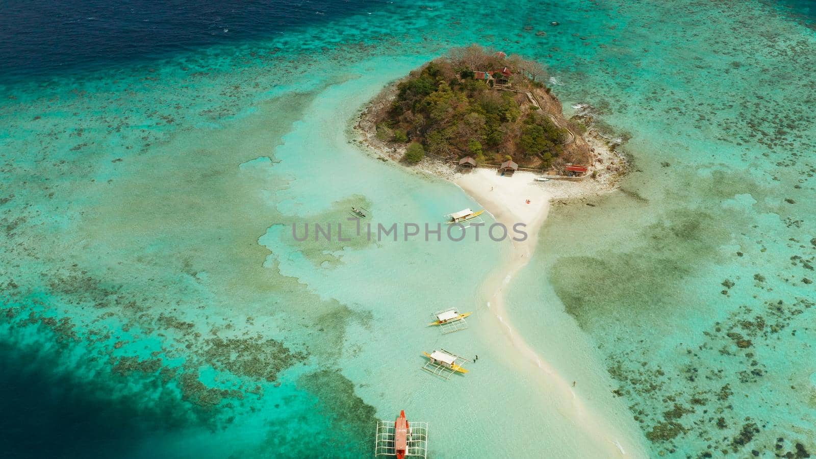 aerial seascape tropical island and sand beach, turquoise water and coral reef. malacory island, Philippines, Palawan. tourist boats on coast tropical island.