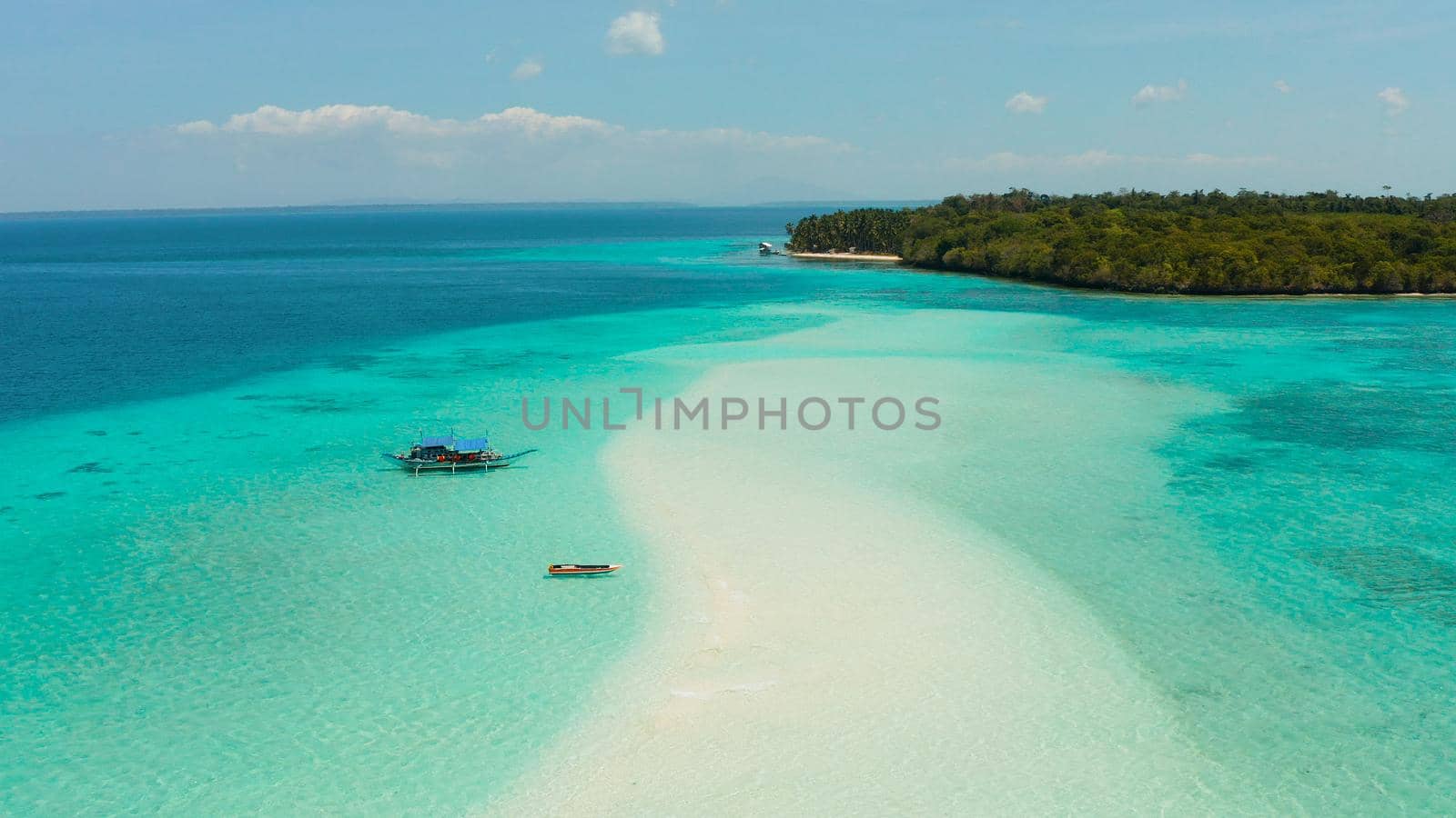Sand bar in transparent turquoise water top view. Tropical beach with tourists. Mansalangan sandbar, Balabac, Palawan, Philippines. Summer and travel vacation concept