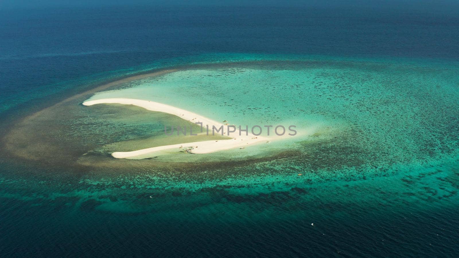 Sandy white island with beach and sandy bar in the turquoise atoll water, aerial drone. Sandbar Atoll. Tropical island and coral reef. Summer and travel vacation concept, Camiguin, Philippines.