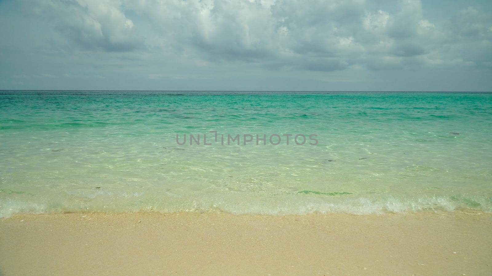 Tropical beach on a background of sky and clouds. Summer and travel vacation concept.