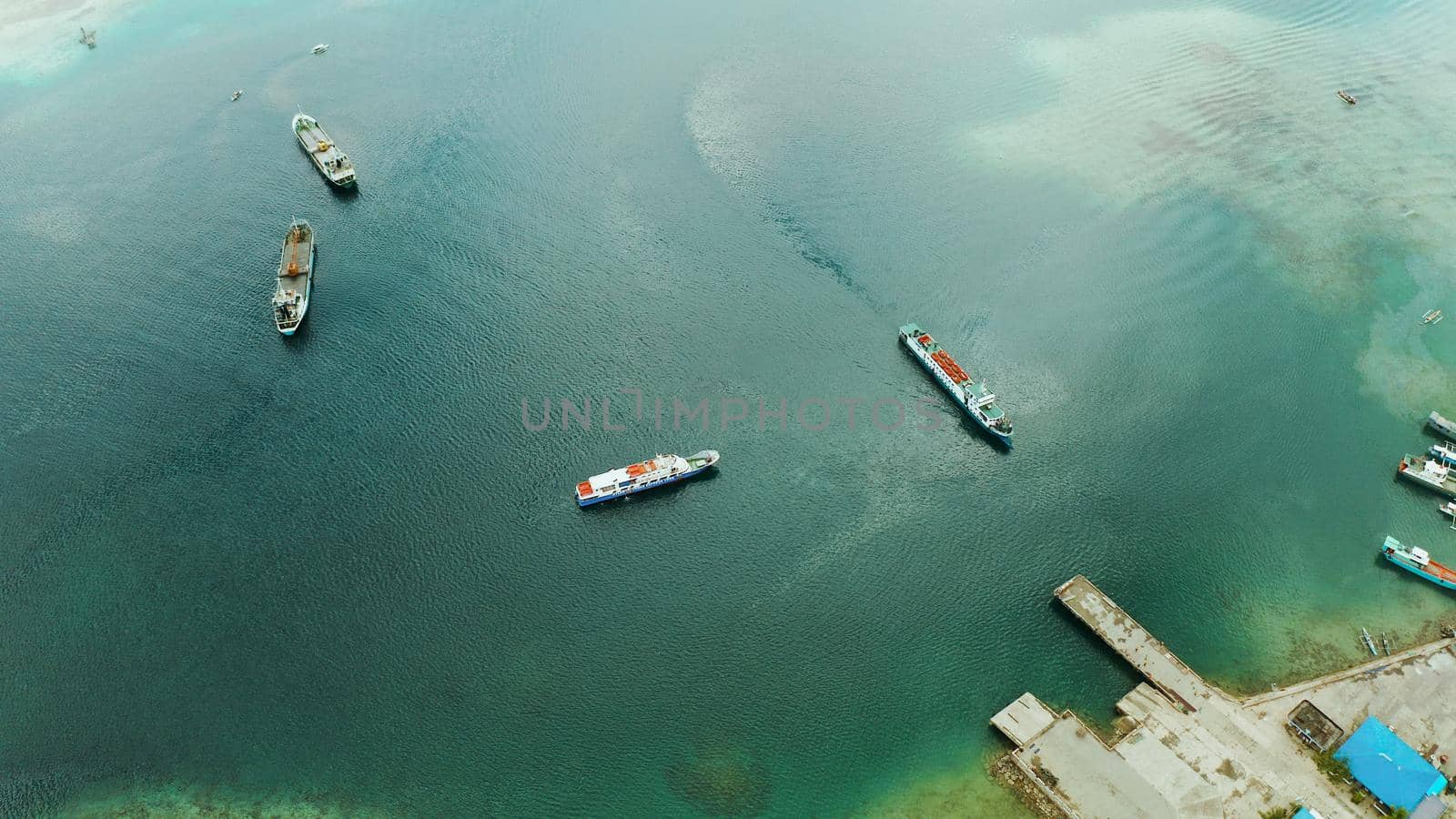Freight ships and ferries in the bay, top view. Dapa Ferry Terminal. Siargao, Philippines.
