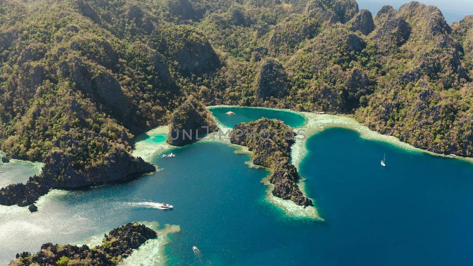 Aerial drone lagoons and coves with blue water among the rocks. lagoon, mountains covered with forests. Seascape, tropical landscape. Palawan, Philippines, Busuanga